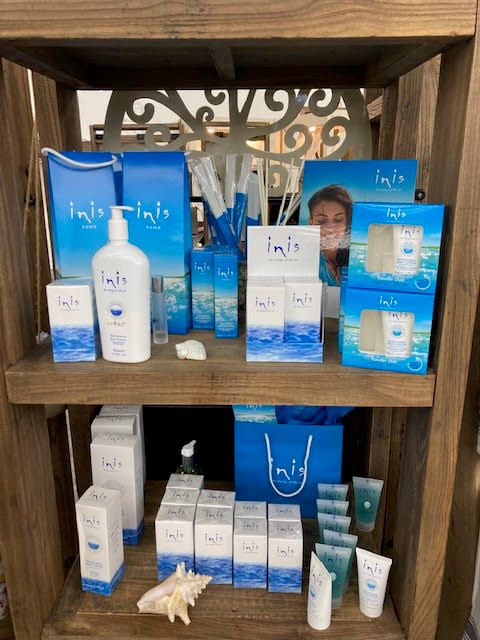 Inis fragrance and body care products displayed on wooden shelves